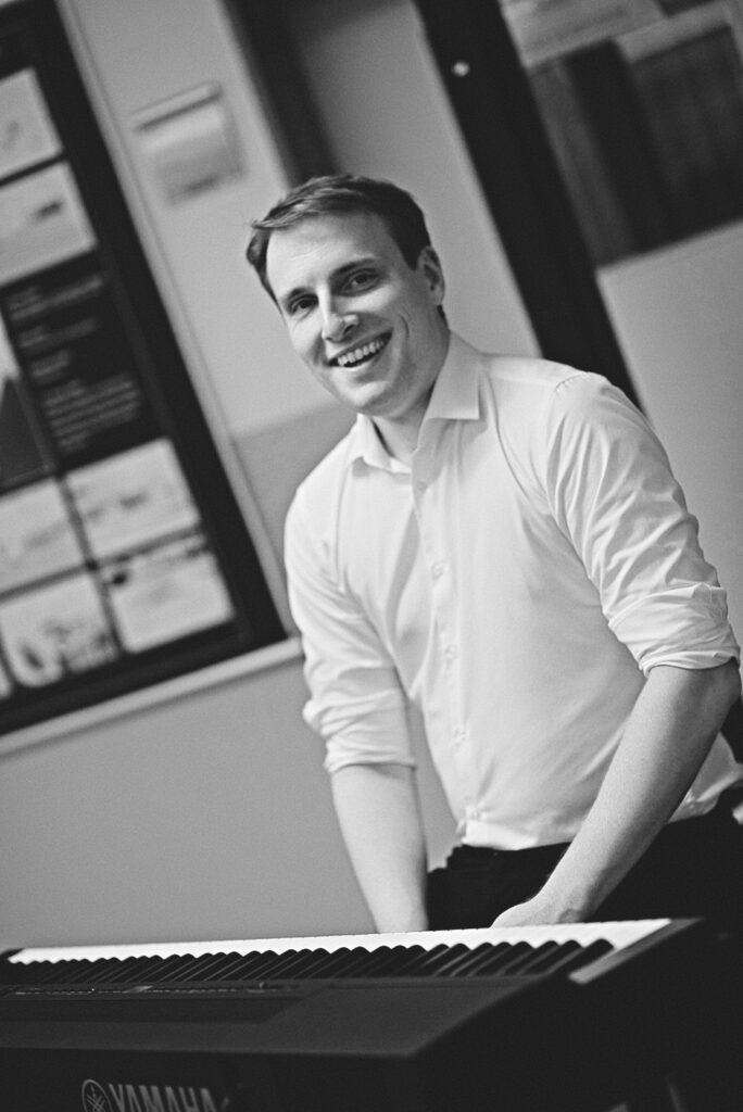 Mann schwarz weiß spielt piano